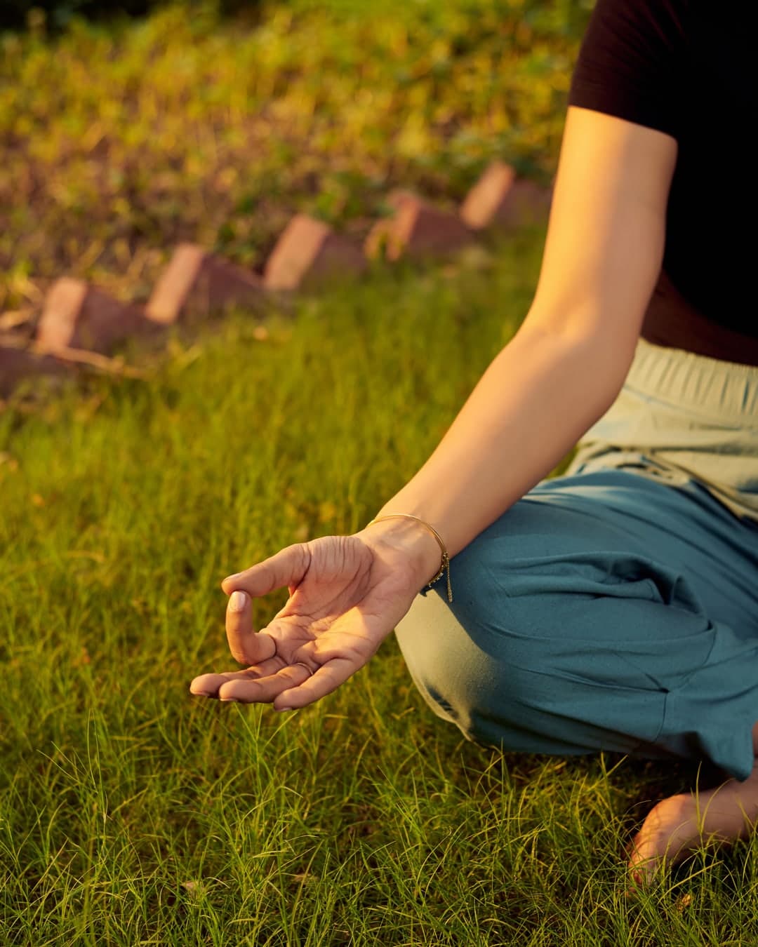 Seated in gyan mudra on the grass